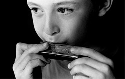 Child playing harmonica
